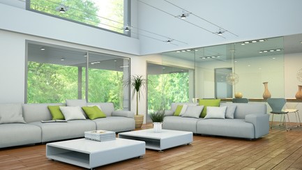 Salon moderne avec des meubles blancs et des accents verts, créant une ambiance lumineuse et accueillante
